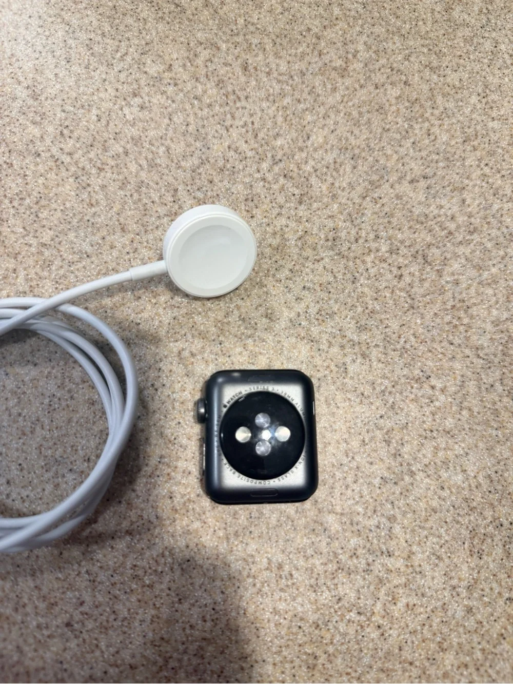 Apple Black Smartwatch with White Magnetic Charger